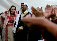 Palestinian bride and groom in traditional costume celebrate their wedding.