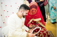 Indian Muslim couple look at the mirror shortly after their wedding. The couple seem to be too shy to look at each other. Modesty is very much valued in traditional Muslim societies.