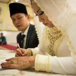 Indonesian bride signs her consent on the dotted line.