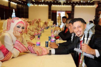 A mass wedding for Palestinian men. Happy couples all despite certain handicaps. Life goes on in blessed Palestine.