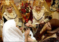 Preparing for a wedding in Algeria. Brides here are adorned with golden headdresses