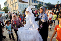 Shy Palestinian bride, Gaza Strip being conveyed to her wedding by female relatives.